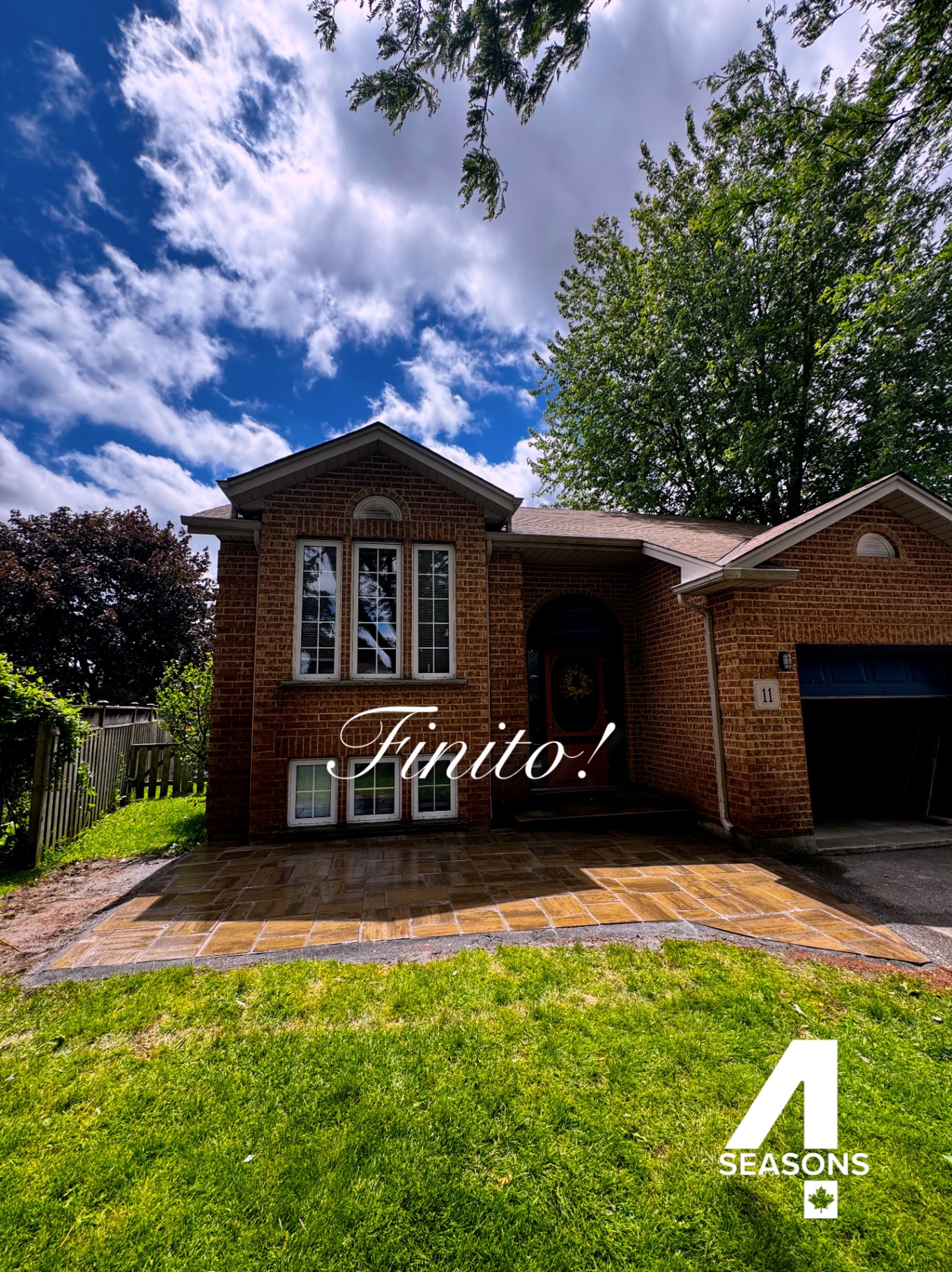 Completed interlocking paver front walkway and landing at a brick home.